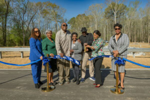 Photo by Catherine Rowell on April 08, 2025. May be an image of 7 people, people standing, park and text.