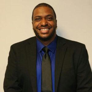 Photo by Fulton County Government on May 02, 2025. May be an image of 1 person, smiling, suit, blazer and text.