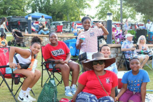 A phot of a family wearing red, white, and blue at the Independence Day Celebration.