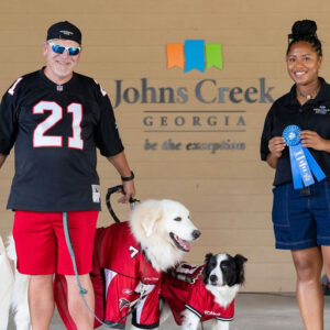 Photo by City of Johns Creek, Georgia on September 17, 2025. May be an image of 2 people, Great Pyrenees, collie and text that says 'দ Hentr JohnsCreek Johns Creek 21 GEORGIA betheexception be the exception T 칼남 > FALEUNE'.