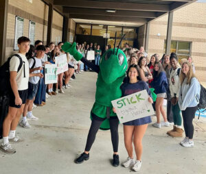Photo shared by Fulton County Schools on September 10, 2025 tagging @roswellhighsch. May be an image of 10 people, people standing and text that says 'STICK Togettier STICK togetier Hornet'.