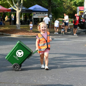 Photo by City of Milton, Georgia on September 09, 2025. May be an image of 9 people, child, golf cart, cooler, grocery bag, wagon, park and text.