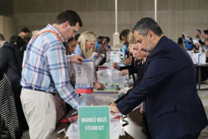 Photo by Hands On Atlanta on May 27, 2025. May be an image of 4 people, petfood and text that says 'MARBLE MARBLEMAZE MAZE STEAM KIT'.