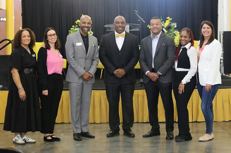 Photo by Atlanta Public Schools on October 24, 2025. May be an image of one or more people, people standing, dais, office and text.