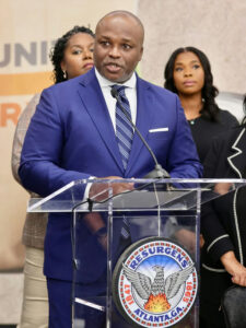 Photo shared by Atlanta Public Schools on October 30, 2025 tagging @apsboe, and @apssupt. May be an image of one or more people, dais and text.