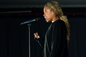 Photo by Georgia Council for the Arts on March 11, 2025. Pode ser uma imagem de 1 pessoa, microfone e texto.