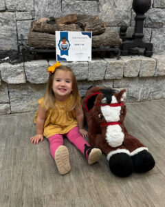 Photo by Fulton County Library System on December 09, 2025. May be an image of baby, smiling, pony, brick wall and text.